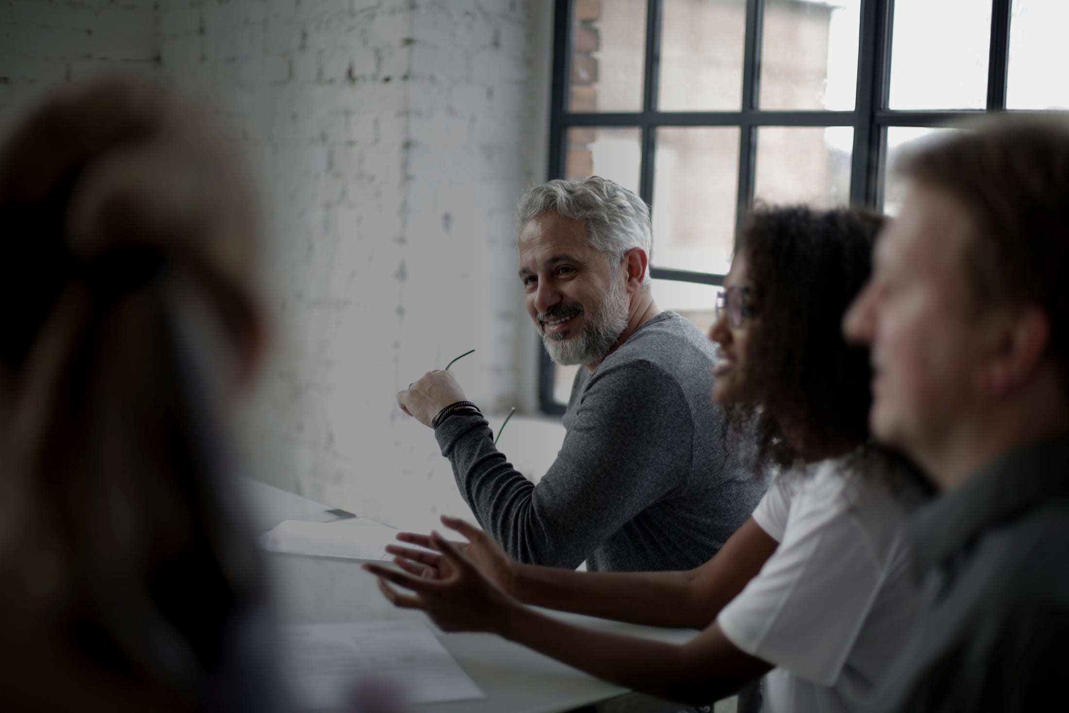 Business owners talking around a table at an in-person meeting